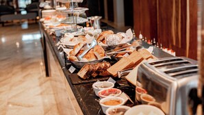 A buffet with various food items and condiments. - Urban by CityBlue Hotel, Dar es Salaam (Dar es Salaam)