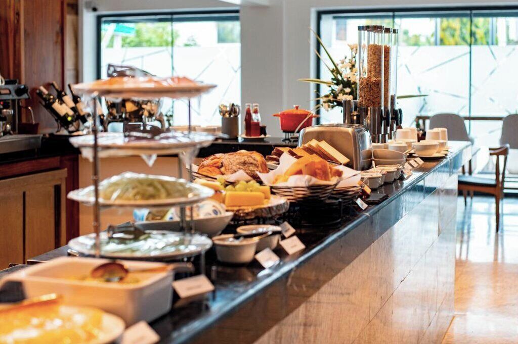 A buffet setup with various food items and a coffee station.