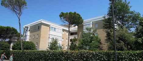 A multi-story residential building with a flat roof and a brick facade.