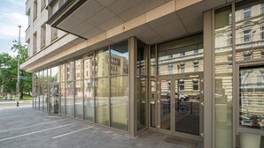 A modern building with large glass windows and a clean, tiled entrance area. - MARGI Eclipse Apartament (Szczecin)