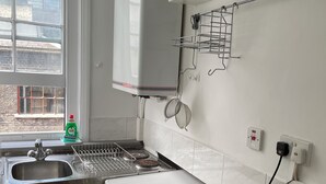 A kitchen with a built-in dishwasher, a stove, and a sink. - SOOTHEUS - SOHO7 (London)