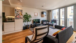 Un appartement moderne comprenant une cuisine, un coin repas et un salon.