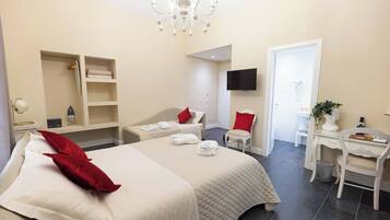 Deluxe Triple Room | Minibar, in-room safe, desk, blackout drapes