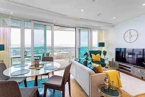 Basic Apartment, Multiple Beds | Living area | TV
