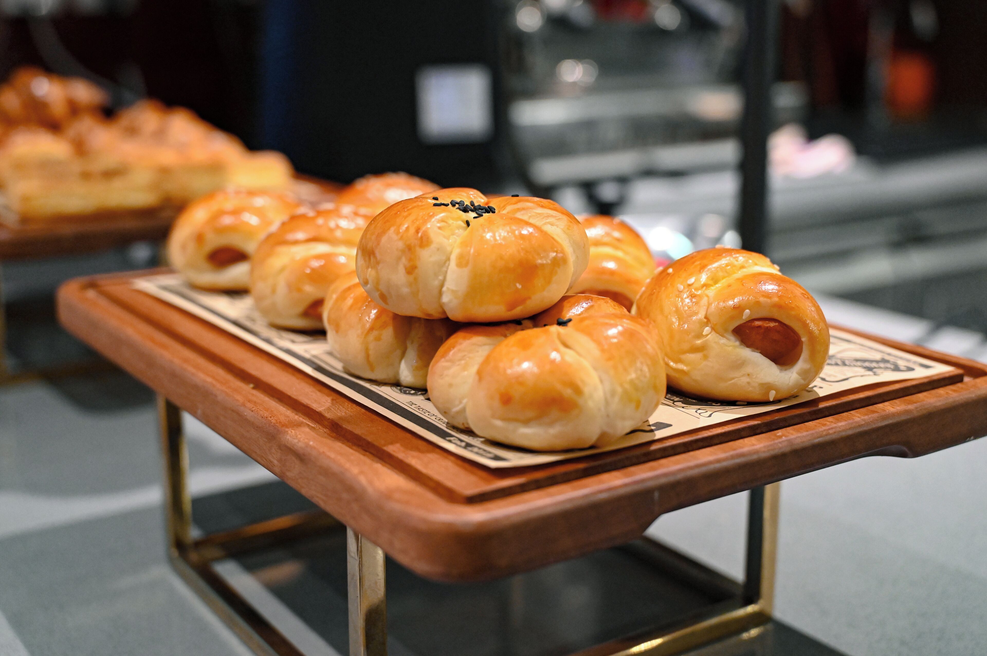 A tray of golden-brown pastries on a wooden serving board.