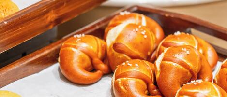 A tray of baked goods including croissants and buns.