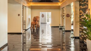 A spacious lobby with a high ceiling, exposed wooden beams, a central chandelier, and a checkered floor. - Coorg Marriott Resort & Spa (Madikeri)