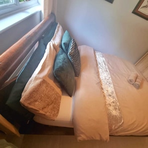 Relax in a cozy bed with a view, surrounded by plush pillows and a soft blanket.