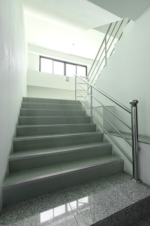 A staircase with metal railings and a number '2' sign above it. - Siam Rama 9 Hotel (Bangkok)