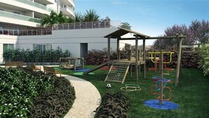 A playground with climbing structures, a slide, and a soccer ball on the grass. - Swimming pool apartment. High standard for family or business people! 4 minutes from the subway! (Pinheiros São Paulo)