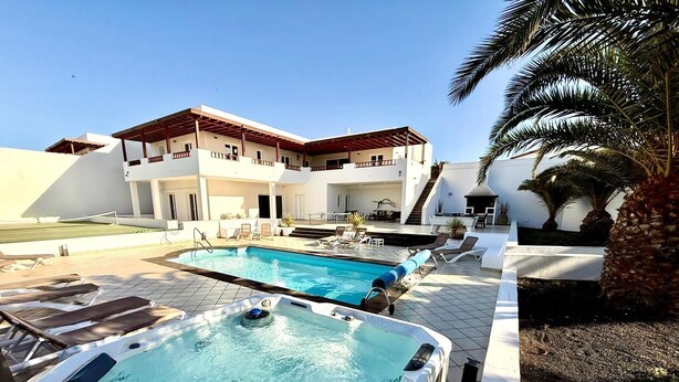 A modern two-story building with a swimming pool and a hot tub. - Incredible 6 bed 5 bath detached villa in the exclusive area of Puerto Calero. (Puerto Calero)