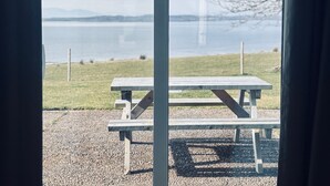 A view of a lake with a wooden picnic table in the foreground. - Bracken Cottage - sleeps 4 guests  in 2 bedrooms (Argyll)