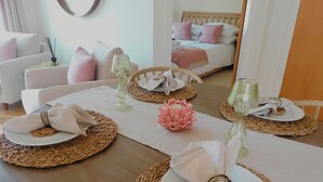 A dining table set with plates, napkins, and glassware, surrounded by woven placemats. - Foxglove Cottage - sleeps 4 guests  in 2 bedrooms (Argyll)