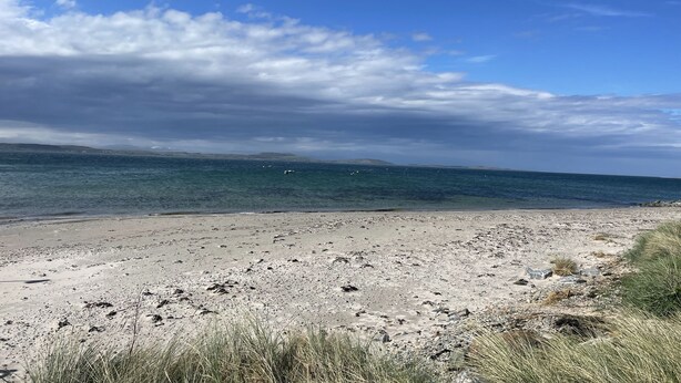 A beach with clear water, distant hills, and a partly cloudy sky. - Foxglove Cottage - sleeps 4 guests  in 2 bedrooms (Argyll)