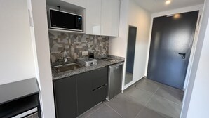 A compact kitchen with a microwave, sink, and dishwasher. - Time22 Apartment Hotel (Amaret Chalhoub)