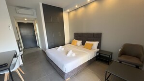 A modern bedroom with a large bed, bedside tables, a desk, and a chair. - Time22 Apartment Hotel (Amaret Chalhoub)