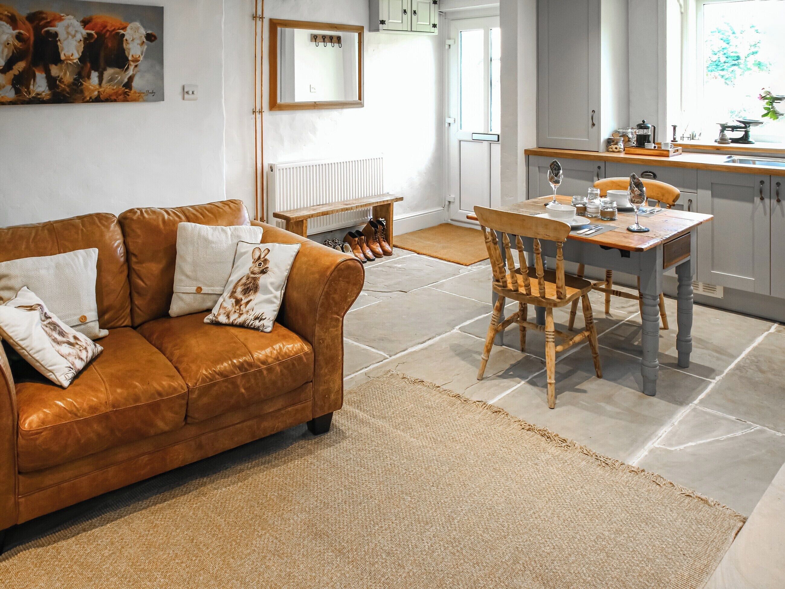 A modern kitchen with a dining table, chairs, and a built-in oven.