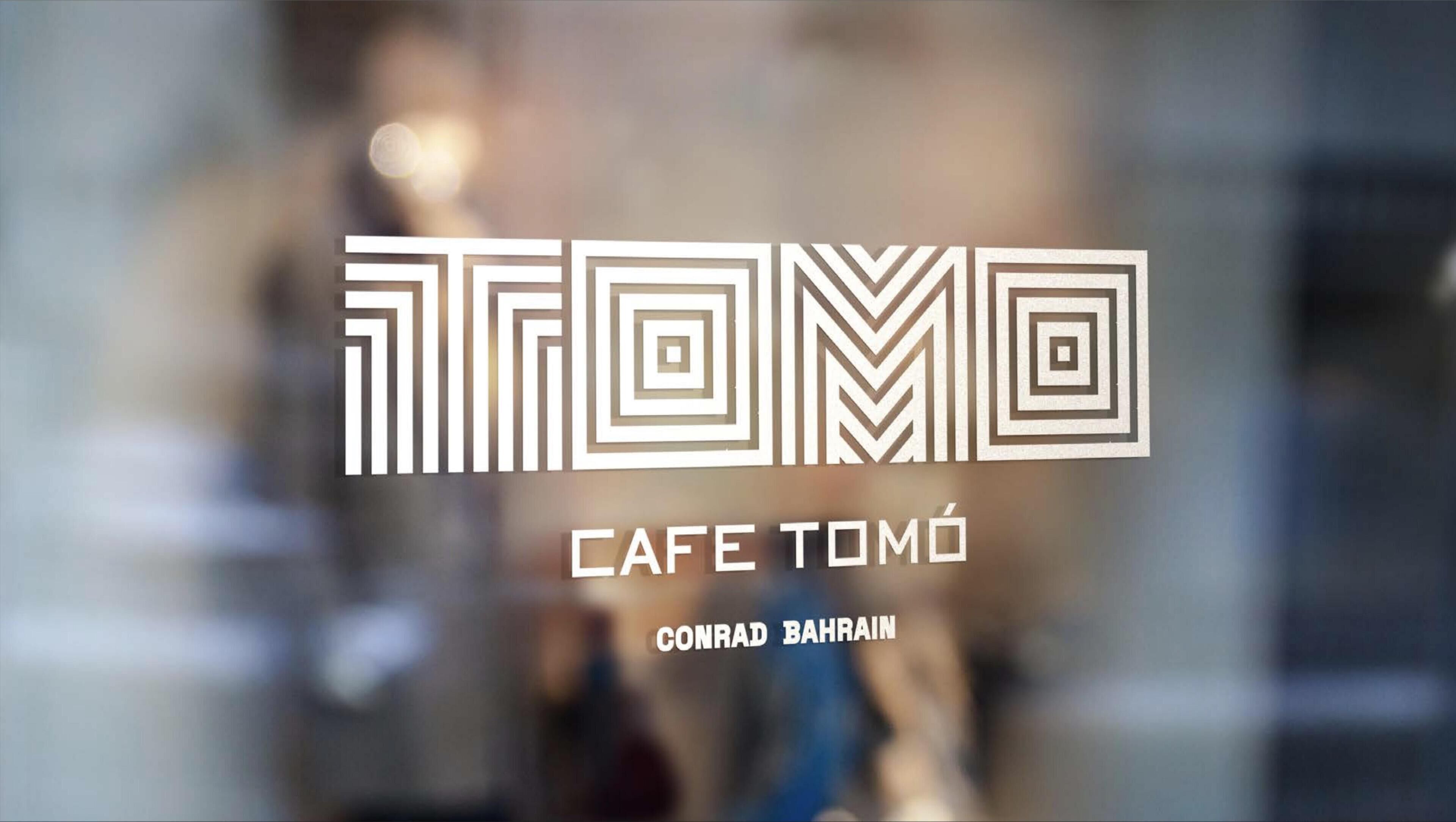 Ein Logo mit geometrischen Mustern und dem Text 'CAFE TOMÓ' und 'CONRAD BAHRAIN'.