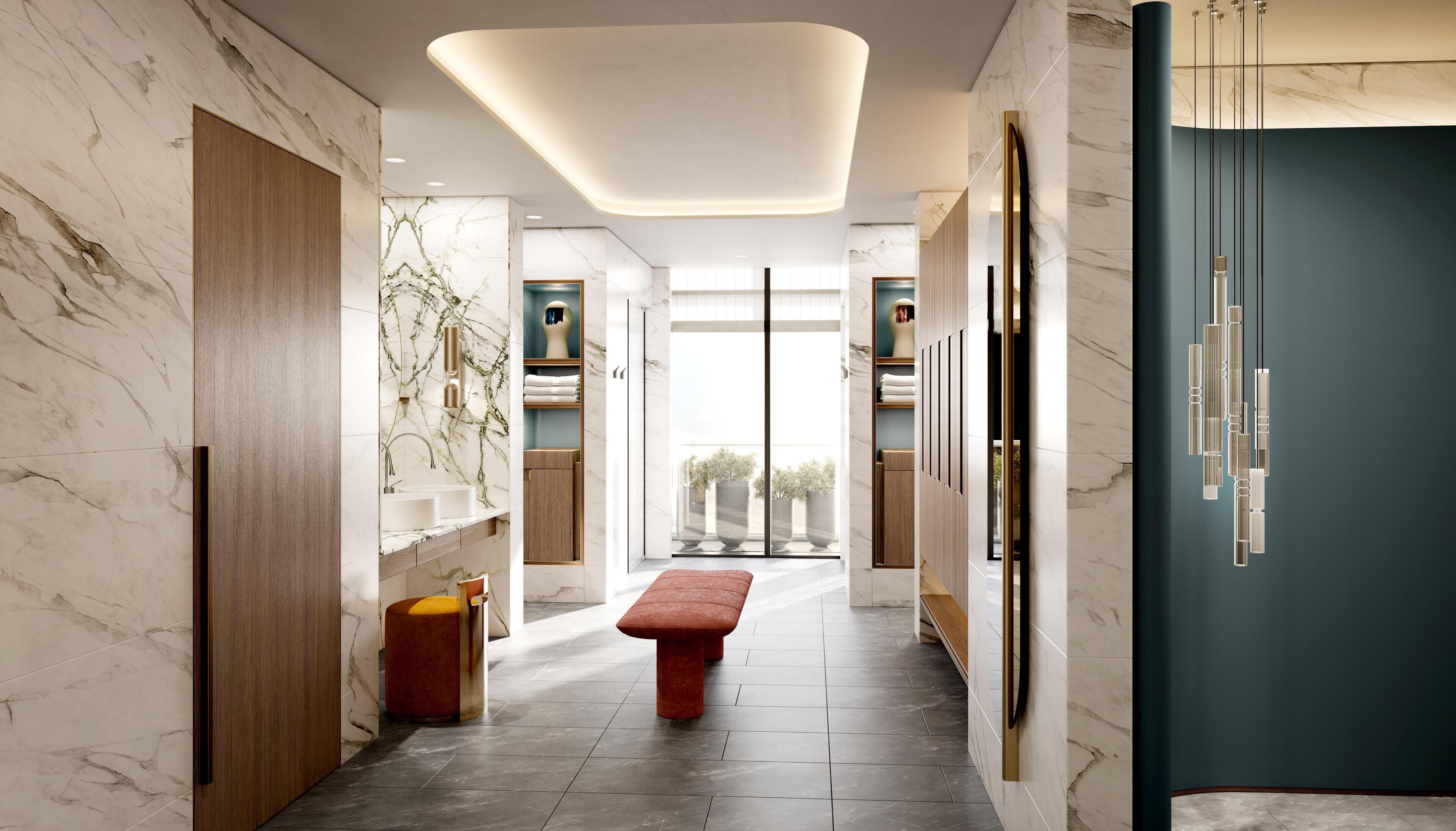 Un couloir moderne aux murs de marbre, avec un banc et une porte dotée d’un luminaire vertical.