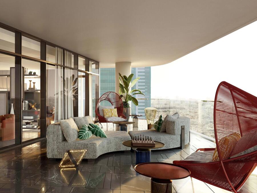 A modern living room with a curved sofa, a red chair, and a view of the cityscape.