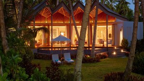 A modern resort with multiple guest rooms, a pool area, and lush tropical surroundings. - Waldorf Astoria Seychelles Platte Island (Platte Island)