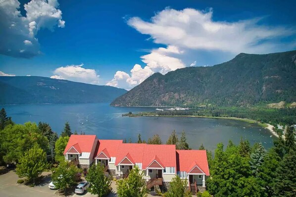 A lakeside property with multiple red-roofed buildings, surrounded by lush greenery and mountains. - Best views in all of Sicamous!
(Sicamous)