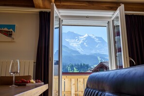 Enjoy a mountain view from the comfort of your room, where you can relax with a glass of wine and a meal.