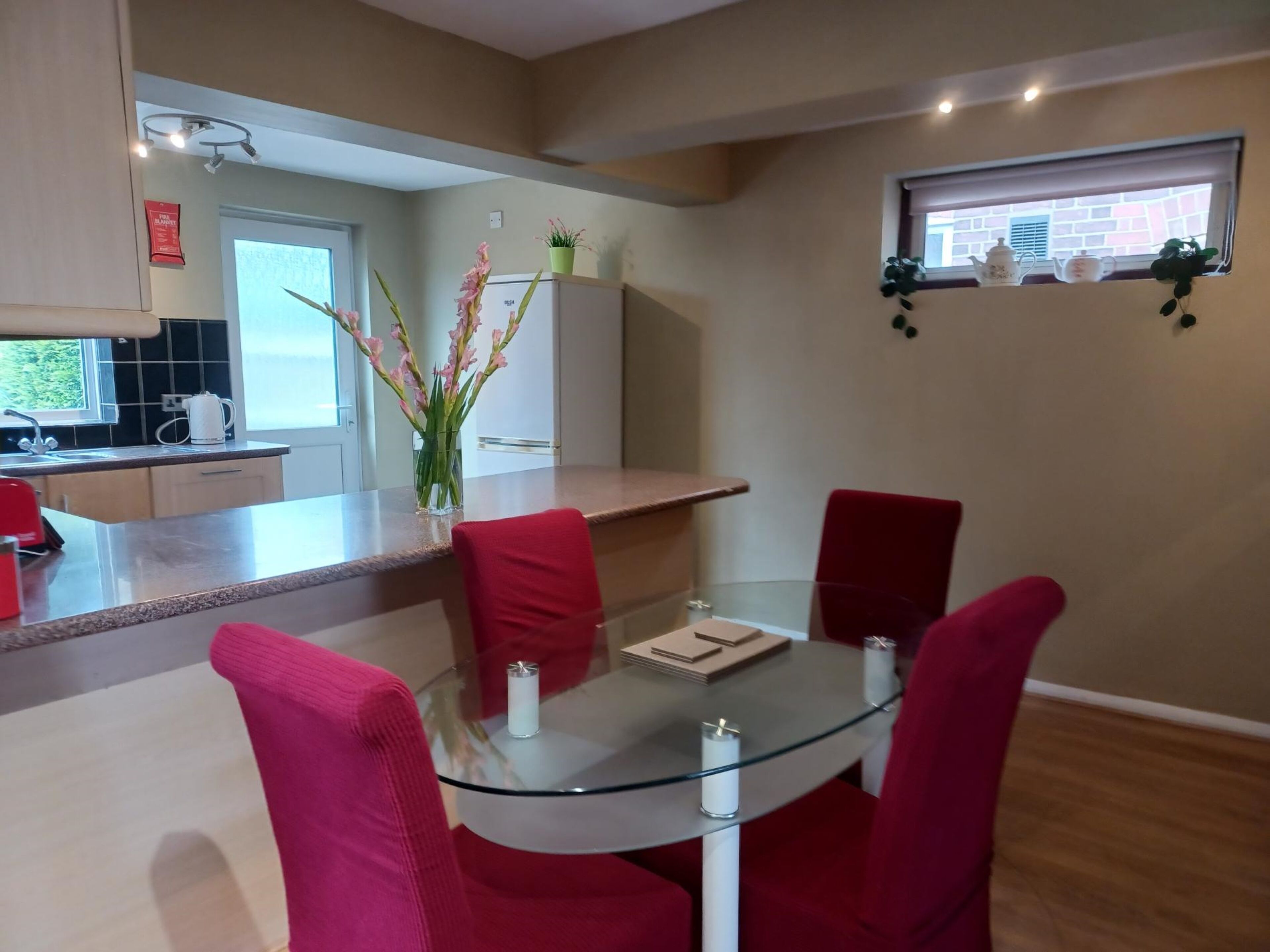 A modern kitchen with a dining area.