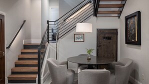 A staircase with wooden steps and metal railings, leading to an upper floor.