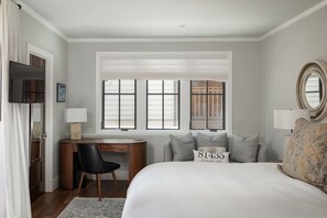 A bedroom with a bed, a desk, a chair, a window with blinds, and a mirror. - The Residence on South Oak - Downtown convenience!, Perfect location by gondola and private hot tub! (Telluride)