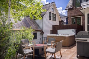 A patio area with a hot tub, seating, and a grill. - The Residence on South Oak - Downtown convenience!, Perfect location by gondola and private hot tub! (Telluride)
