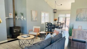 A modern living room with a sofa, a round coffee table, and a fireplace.