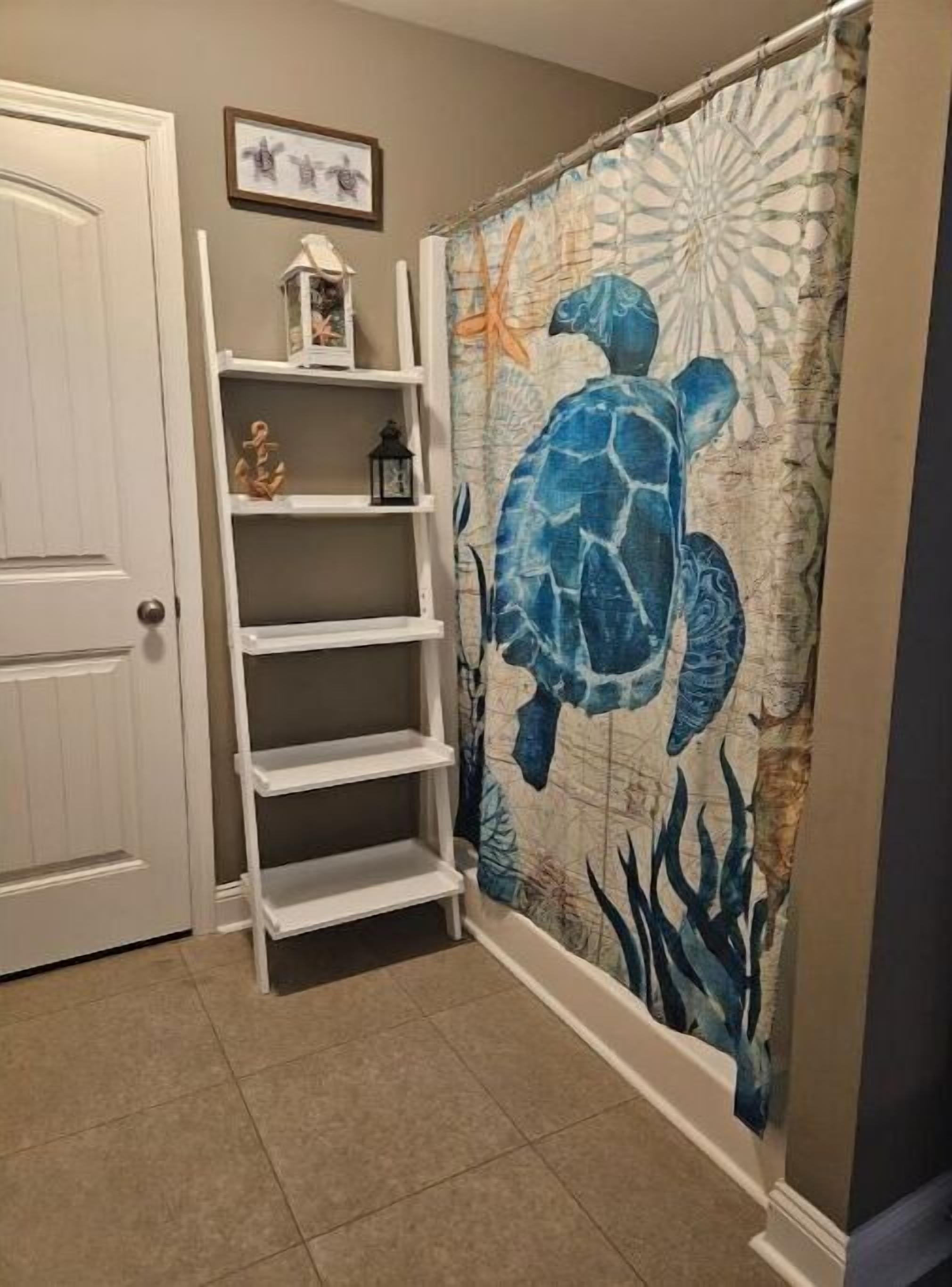 A hallway with a white door, a white shelf unit, and a blue sea turtle mural on the wall.