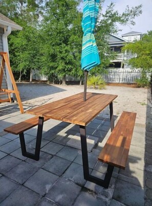 Enjoy al fresco dining on the patio with a picnic table and matching benches.