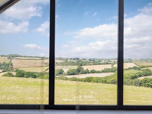 A view through a window of a rural landscape with fields and trees. - The Old Coach Garage (Gerrans)