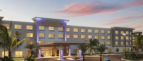 A hotel with a modern facade, multiple entry points, and a well-lit entrance.