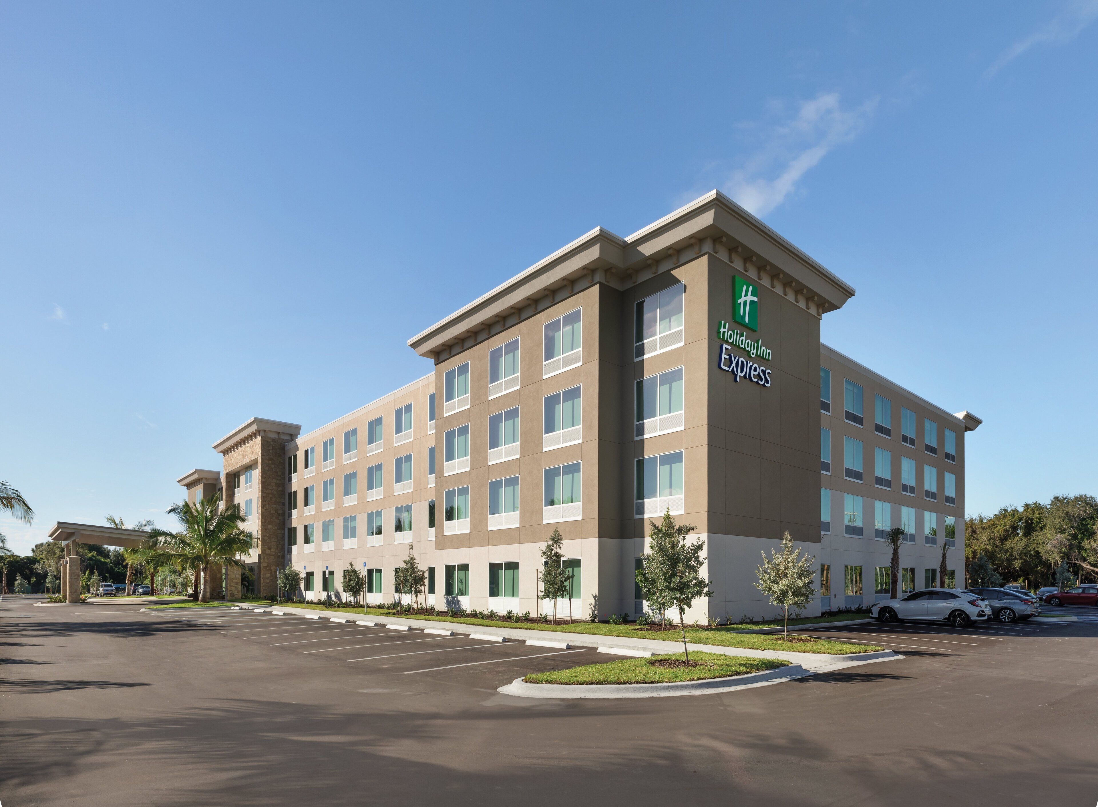 A Holiday Inn Express building with a modern design, featuring a flat roof and a symmetrical facade with multiple windows.