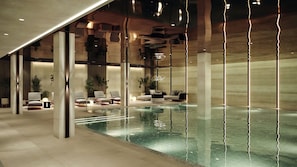 A modern indoor swimming pool with lounge chairs and a minimalist design. - Crowne Plaza Tashkent by IHG (Tashkent)