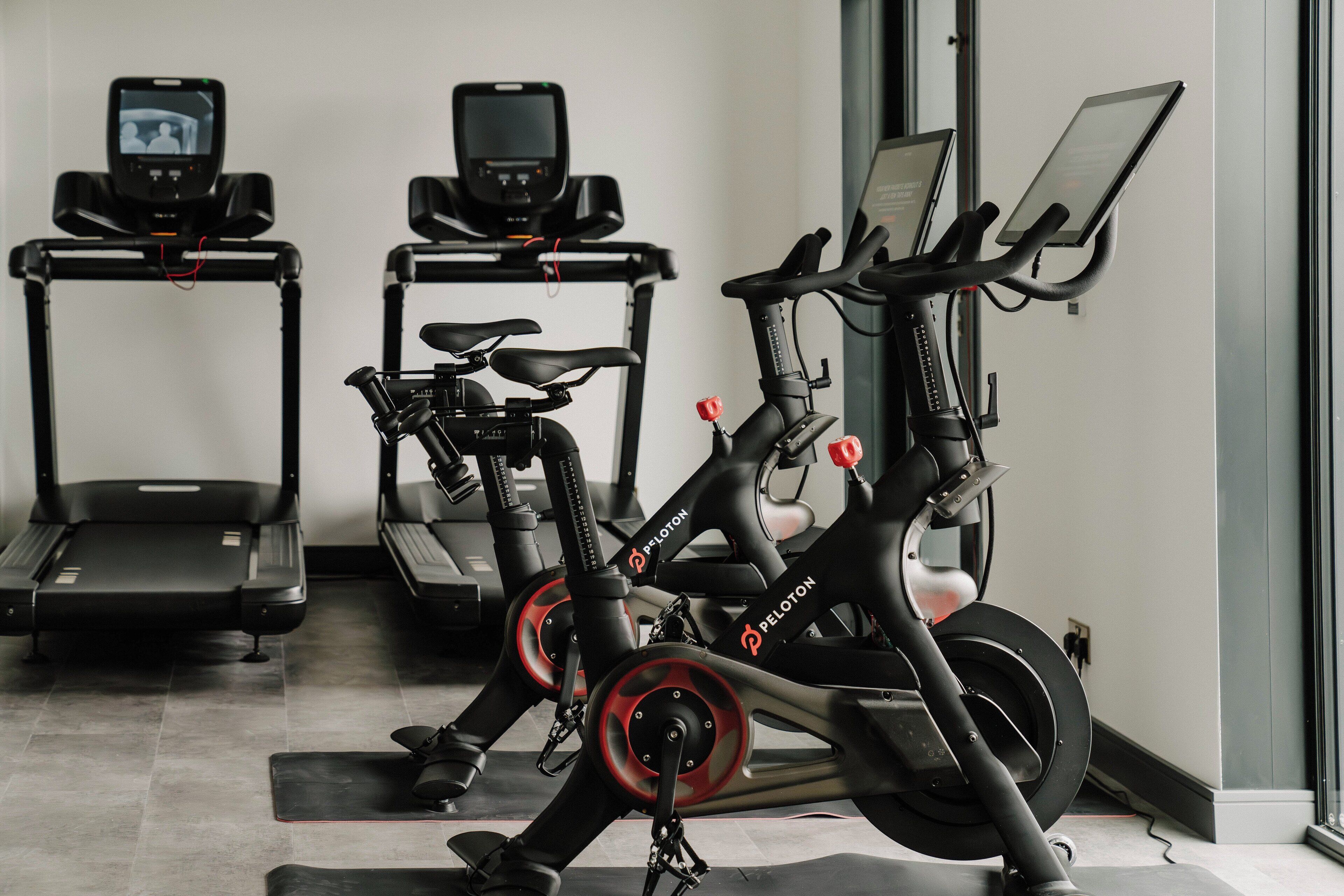 A gym with stationary bikes, treadmills, and exercise equipment.