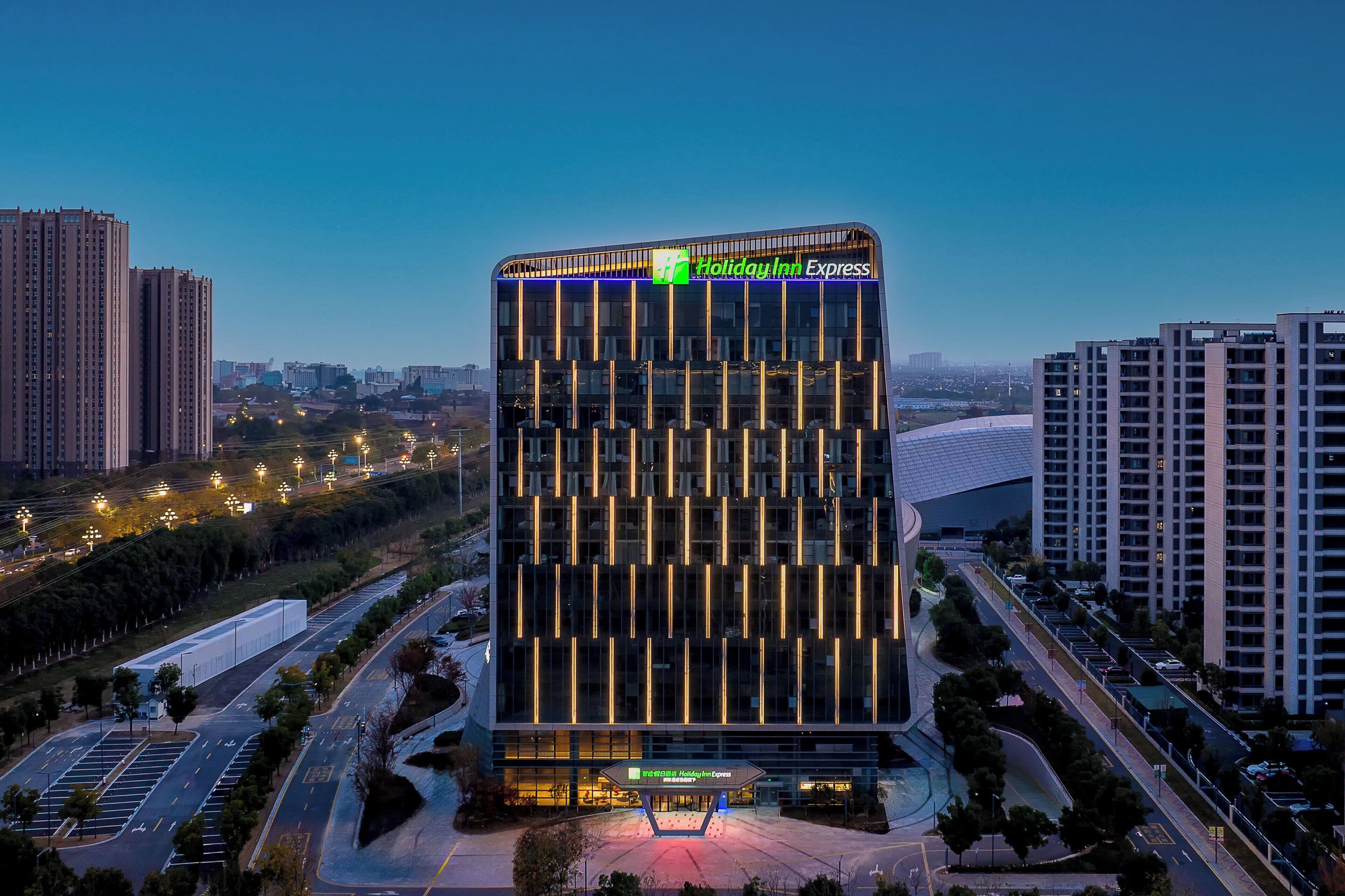 A modern hotel building with a prominent sign for Holiday Inn Express.