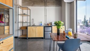 A modern kitchen with wooden cabinets, a built-in sink, and a view of the city through large windows. - Triver Florencia (Mexico City)