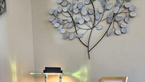 A desk with a lamp, a framed menu, and a small shelf with a bottle and a plant. - Quiet Stay in Elephant Butte Near Lake & Golf Course (Truth or Consequences)