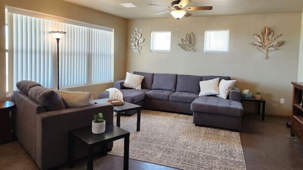 A living room with a sectional sofa, a small table with a plant, and a ceiling fan. - Quiet Stay in Elephant Butte Near Lake & Golf Course (Truth or Consequences)