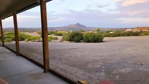 A covered outdoor area with a view of a mountain and sparse vegetation. - Quiet Stay in Elephant Butte Near Lake & Golf Course (Truth or Consequences)