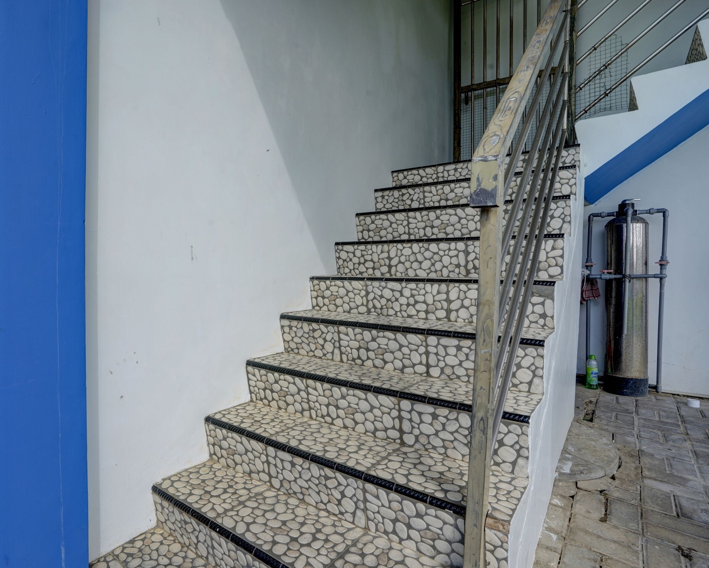 A staircase with stone steps and metal railings.