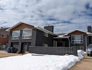 Situated in a quiet suburban neighborhood, this two-story home offers a front entrance and a garage.