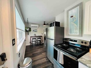 Enjoy cooking in this well-equipped kitchen with a refrigerator, stove, and microwave.