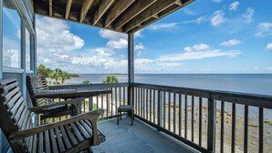 A wooden deck with a view of the ocean and beach. - Fenimore Mill 1C - Pool and Beautiful Gulf Views! (Cedar Key)