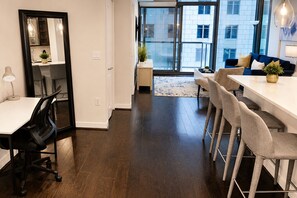 A modern kitchen with a dining area, a large window, and a view of the city. - The Luxe | City View | Romantic Escape (Atlanta)