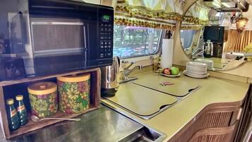 Fridge, microwave, coffee/tea maker, cookware/dishes/utensils